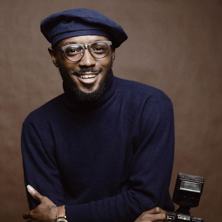 Alex Rivera, Lead Design Curator at YonderWispGlen, reviewing corporate floral arrangements